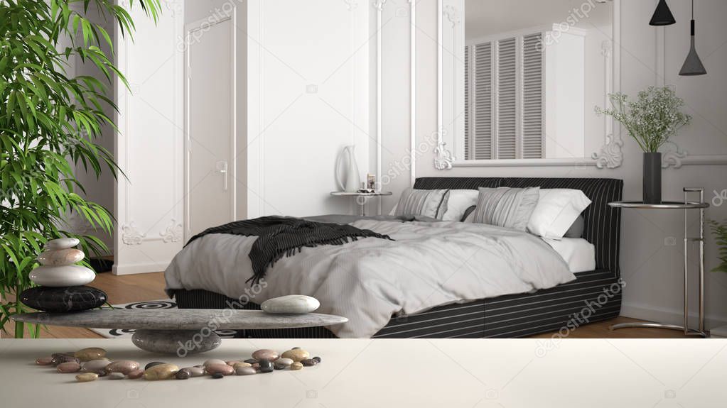 White table shelf with pebble balance and 3d letters making the word feng shui over classic white and gray bedroom in contemporary apartment, zen concept interior design