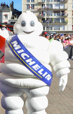 LE MANS, FRANCE - JUNE 16, 2017: White inflatable man - emblem of the company Michelin on a parade of pilots racing at Le mans, France clipart