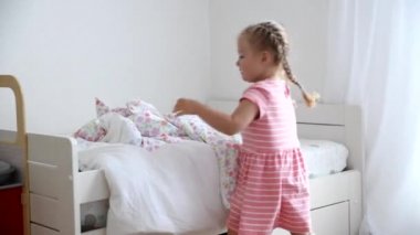 3 yaşında bir kız çocuk odasında bir yatak yapar