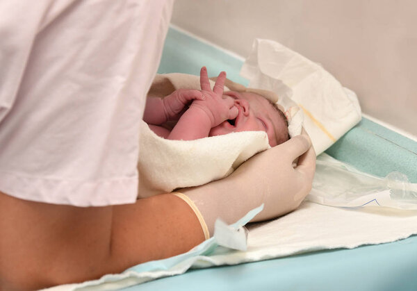 Nurse caring for newborn after childbirth