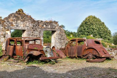 Destroyed cars during World War 2 in Oradour sur Glane France clipart