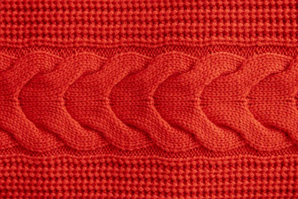 Red knitted winter sweater Background, red texture