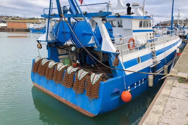 Rusty boat and nets for catching scallops
