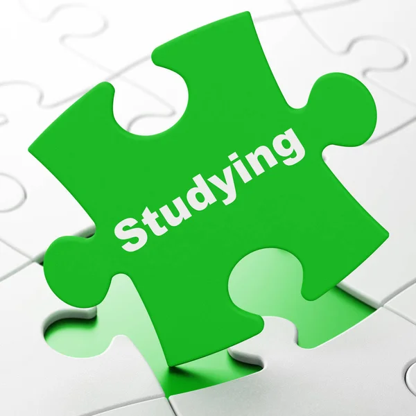 Education concept: Studying on puzzle background — Stock Photo, Image