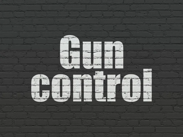 Safety concept: Gun Control on wall background