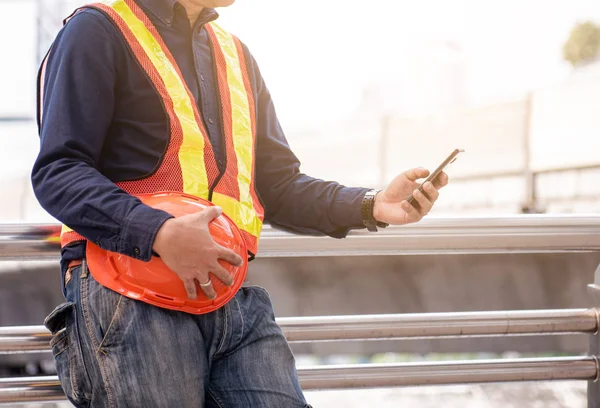 Engineers prepare for the job with Orange Helmet and Mobile Phone.