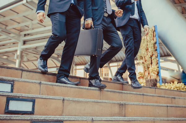 defocused or blured Businessman walking the stairs with city background, Businessmen go to success concept, vintage style.