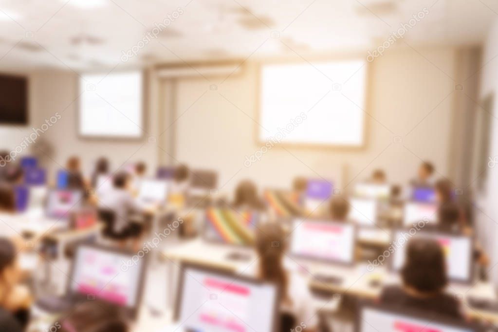 Blurred background of business people in conference hall or seminar room with desktop computer.