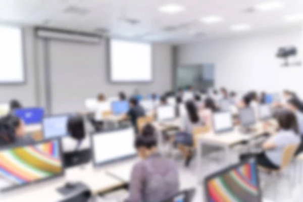 Blurred background of business people in conference hall or seminar room with desktop computer.