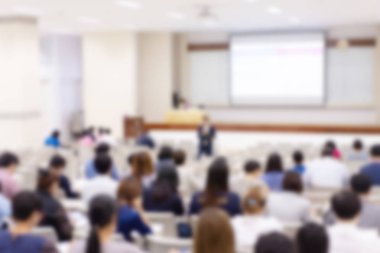 Konferans salonu veya seminer odasındaki iş adamlarının geçmişi bulanık.