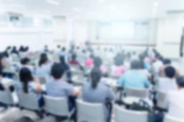 Blurred background of business people in conference hall or seminar room.