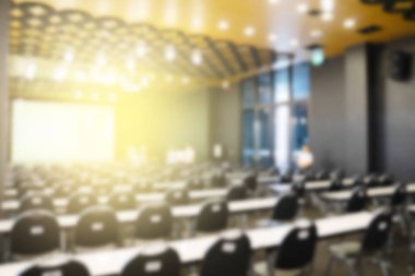 Konferans salonu veya seminer odasındaki iş adamlarının geçmişi bulanık.