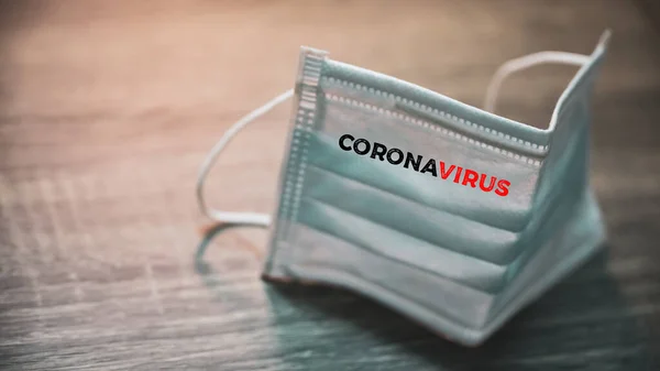 Inscription Corona virus on Surgical mask with rubber ear straps. antivirus medical mask for protection covid-19. Protection corona virus concept.