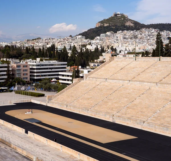 View of the ancient stadium of the first Olympic Games in white marble -Panathenaic Stadium - overlooking Lykavitos hill in the city of Athens, Greece