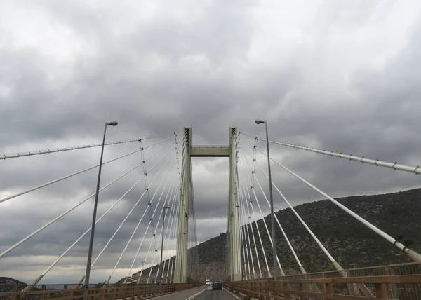 Bridge to Evia island in Greece on a cloudy day with thunderclouds in the calm Aegean Sea