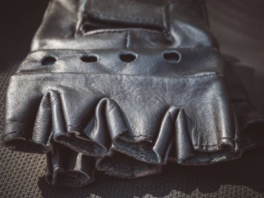 Parmakları olmayan motorcular için siyah eldivenlerin deri dokusu.