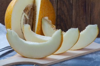 Kesme tahtasıüzerinde üç dilim olgun kavun