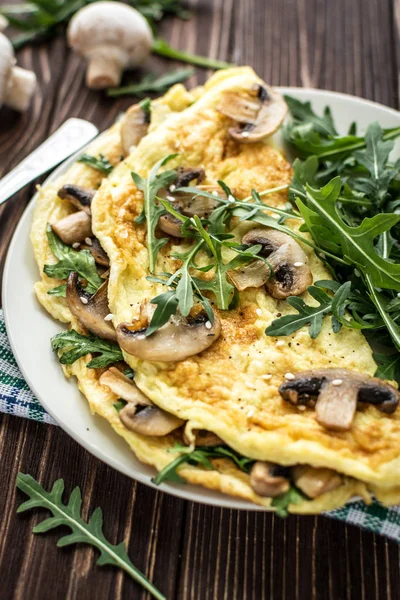 Hausgemachtes Omelett Mit Pilzen Und Rucola Auf Hölzernem Hintergrund — Stockfoto