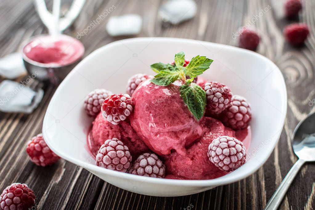 Homemade delicious ice cream  made from fresh berries on a wooden background