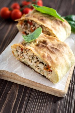 Ahşap arka plan üzerinde etli lezzetli ev yapımı strudel