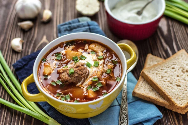 Etli lezzetli geleneksel Ukrayna borsch. Plaka rustik arka plan üzerinde kırmızı pancar çorbası. Geleneksel Ukrayna yemek mutfağı