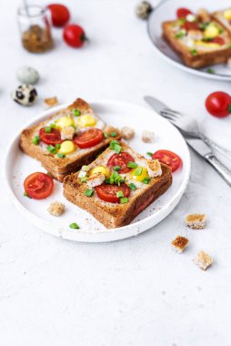 Jambon ve sahanda yumurtalı sandviç, jambon ve domatesli sahanda yumurta ve gri beton masa. kaybet-up, üst görünüm.