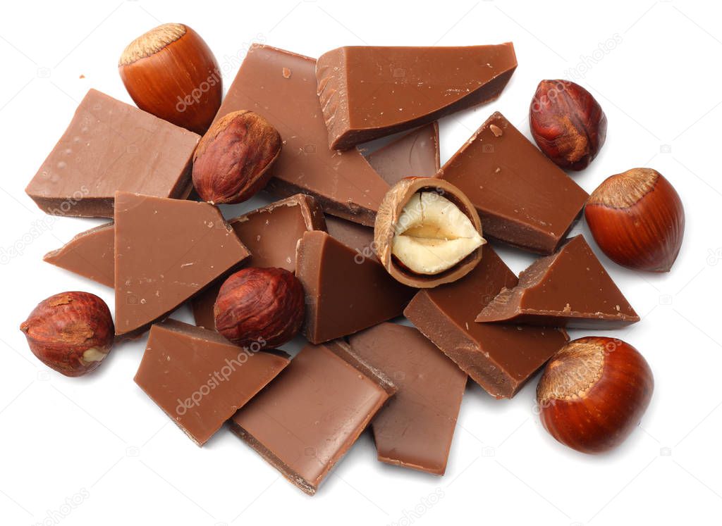 cracked chocolate candies sweets with nuts isolated on white background top view