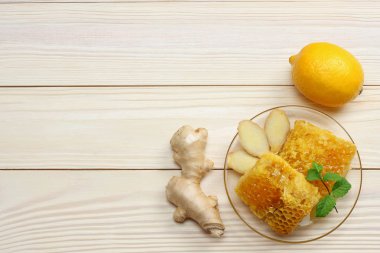 sağlıklı arka plan. Tatlım, petek, limon, zencefil beyaz tahta masada. Kopya alanı ile üstten görünüm