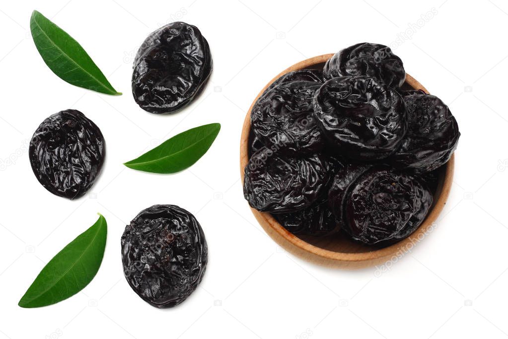 Dried plums - prunes with green leaves isolated on white background. top view