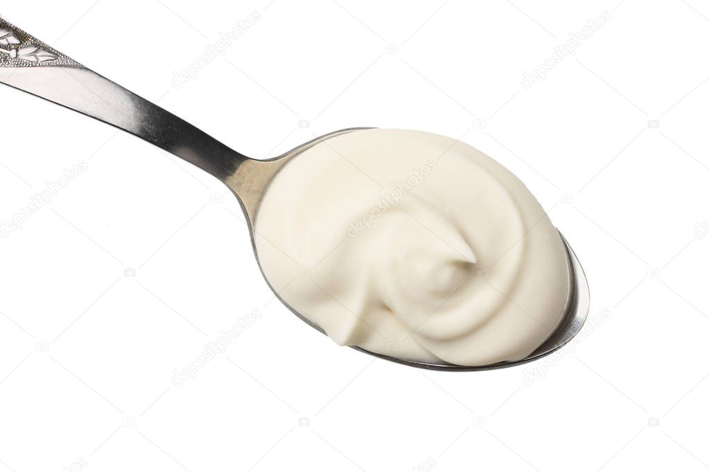 sour cream in spoon isolated on white background
