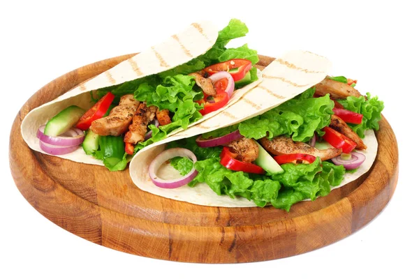 Tortilla wrap with fried chicken meat and vegetables on wooden board isolated on white background — Stock Photo, Image