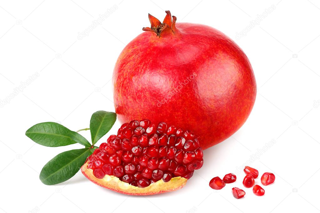 piece of pomegranate with seeds and green leaves isolated on a white background. 