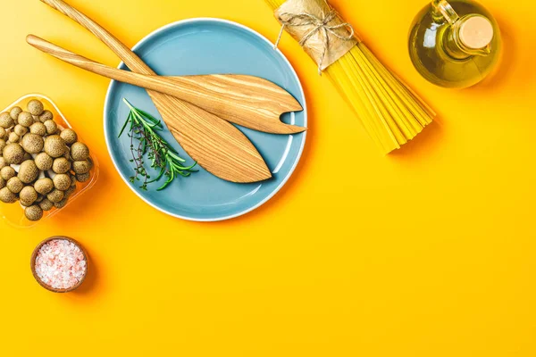 Flat lay, healthy food concept over yellow surface
