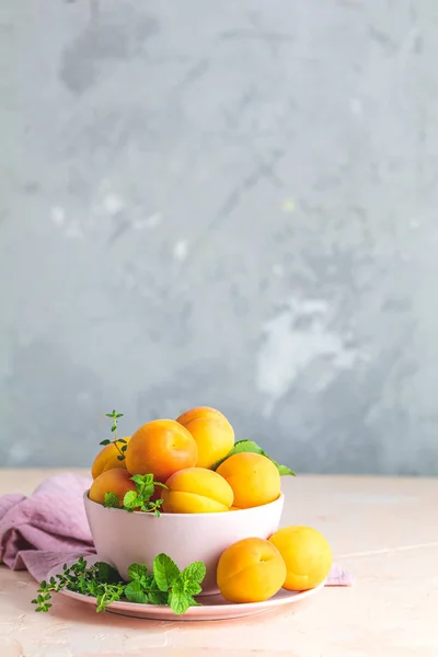 Albaricoques naranjas dulces frescos en cuenco rosa —  Fotos de Stock