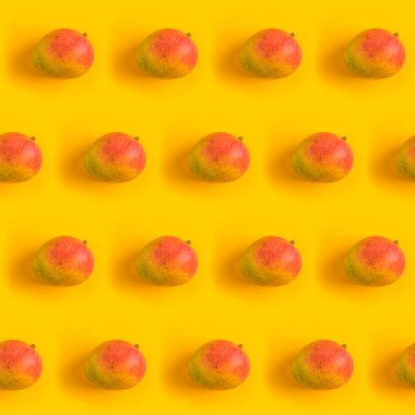 Pattern with ripe mango on yellow background. Top View. Copy Space. Pop art design, creative summer concept. Mango in minimal flat lay style.	