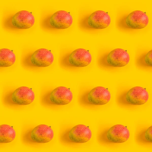 Pattern with ripe mango on yellow background. Top View. Copy Space. Pop art design, creative summer concept. Mango in minimal flat lay style.	