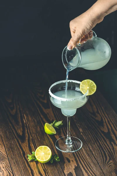 Woman Hands Pouring Margarita Cocktail Lime Ice Dark Wooden Background — Stock Photo, Image