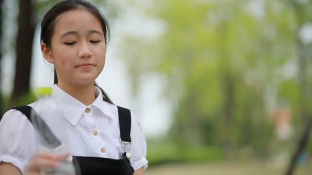 Asian Teenager Drinking Water Plastic Bottle — Stock Video