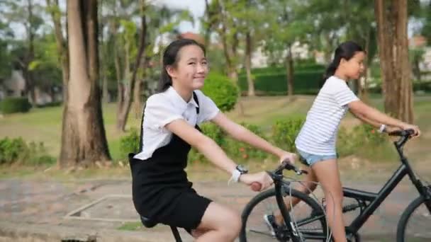 Dois Asiático Adolescente Equitação Bicicleta Aldeia Parque — Vídeo de Stock