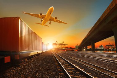 cargo plane flying over container trains and commercial shipyard background clipart