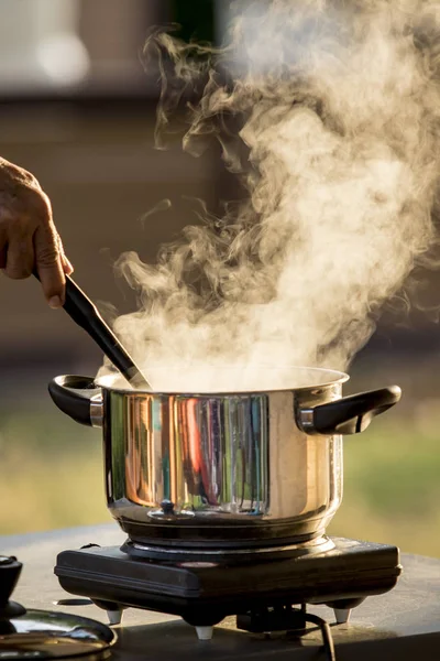 Steam flowing from cooking pot against beautiful morning light — Stock Photo, Image