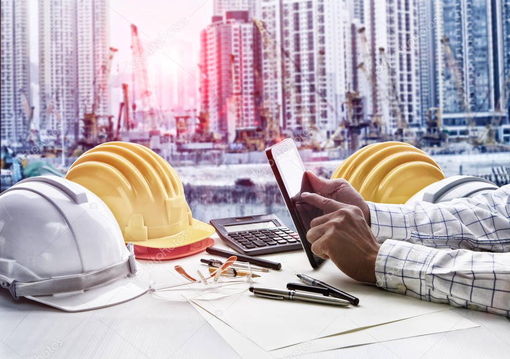 contractor man working  on office table against construction sit