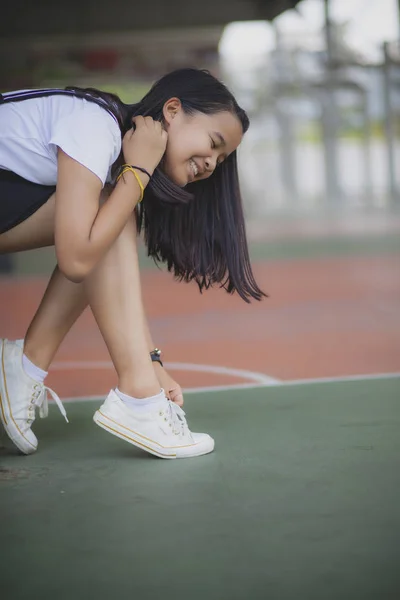 Asian teenager wearing sneaker shoe in indoor sport club — Stock Photo, Image