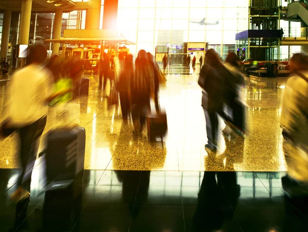 Passenger with traveling luggage walking in airport terminal — Stock Photo, Image