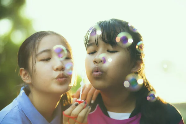 Couples of asian teenager relaxing with soup bubble against beau — Stock Photo, Image