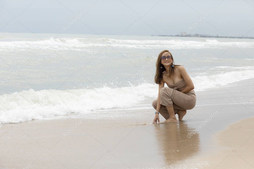 beautiful woman relaxing with happiness emotion on sea beach