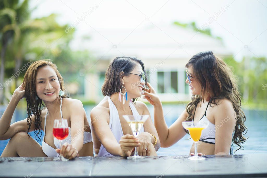 three younger asian woman happiness drinking beverage in waer sw