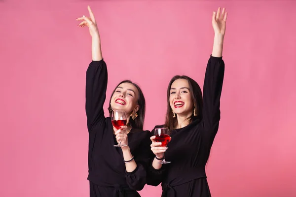 Zwei schöne Mädchen Zwillinge feiern Corporate Neujahrsparty, trinken Wein und reden — Stockfoto