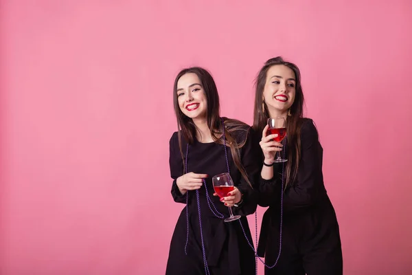 Two women celebrate the New Year party having fun laughing and drinking wine. — Stock Photo, Image