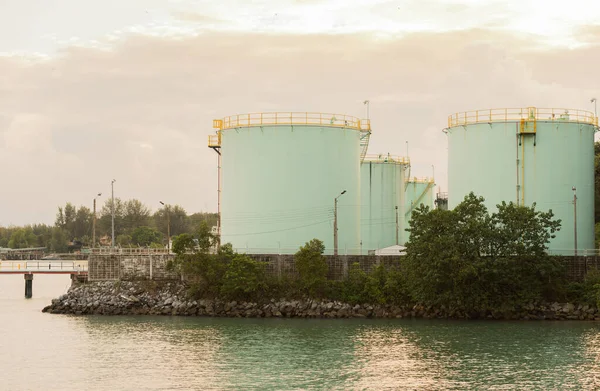 Industrial light green Fuel Tanks side  the sea at sunset time. — Stock Photo, Image